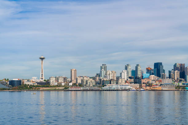 istock Waterfront Seattle skyline with iconic view observation tower called Space Needle. Skyscrapers of financial downtown at day time, Washington, USA. A vibrant business neighborhood 1363634821