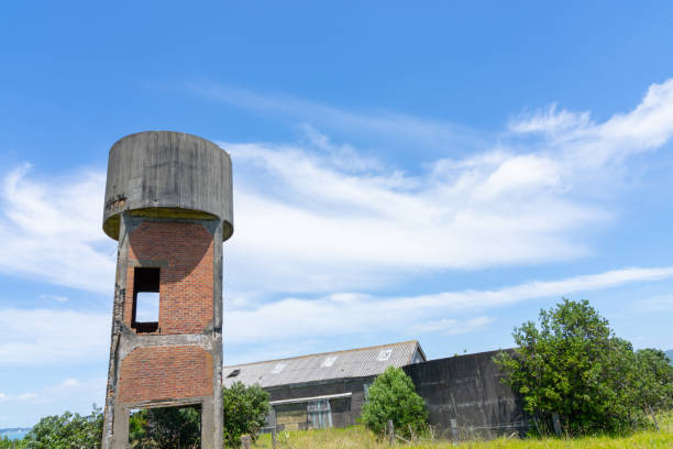 istock Old wooden and asbestos barracks and brick water tower 1363635595