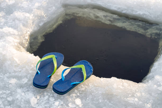 Ice hole and sneakers close-up. stock photo