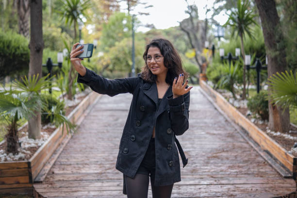 Young woman vlogging on vacation in autumn