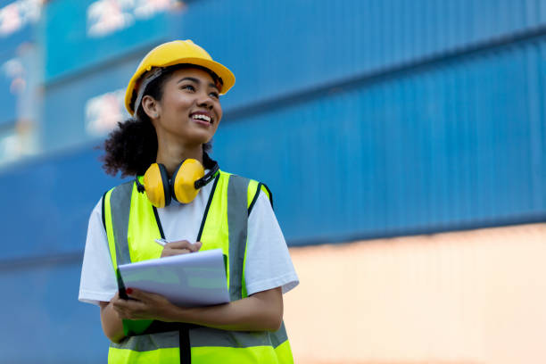 Foreman or worker hand holding checklist for writing and checking in goods in container at Container cargo site. Foreman or worker hand holding checklist for writing and checking in goods in container at Container cargo site. occupation stock pictures, royalty-free photos & images