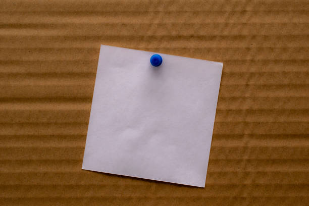 istock white blank note pinned to a notice board with a paper clip. 1363637834