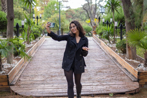 istock Young woman vlogging on vacation in autumn 1363638008