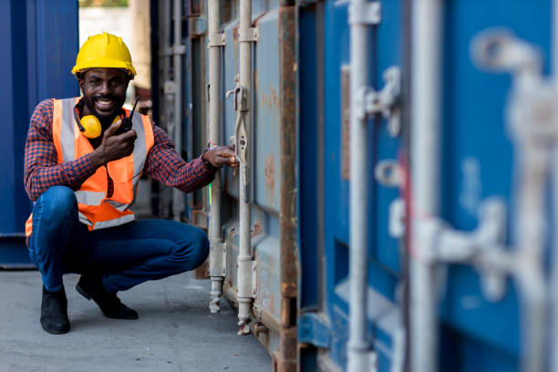 istock Foreman holding walkie- talkie for control working at Container cargo site. Handheld walkie talkie for outdoor 1363638053