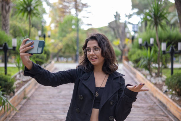 istock Young woman vlogging on vacation in autumn 1363638688
