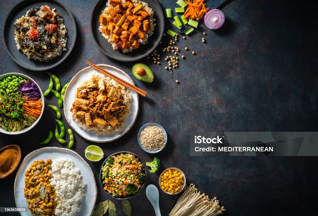 Vegan plant based asian food recipes with rice and brown rice as Asian Vegan Rice recipes plant based assorted as sushi bowl, Poke, chickpeas Masala, stir fried rice with tofu, Mapo tofu brown rice and braised eggplant rice Food Stock Photo