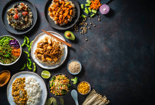 Vegan plant based asian food recipes with rice and brown rice as Asian Vegan Rice recipes plant based assorted as sushi bowl, Poke, chickpeas Masala, stir fried rice with tofu, Mapo tofu brown rice and braised eggplant rice vegetarianism stock pictures, royalty-free photos & images