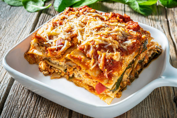 Protein rich Lasagna Vegan Italian food plant based recipe Medit Protein rich Lasagna Vegan Italian food plant based recipe Mediterranean diet with ingredients as Lasagna pasta, onion, mushrooms, zucchini, bell pepper, spinach, vegan marinara sauce, tomatoes, firm tofu, chick peas, vegan cheese spinach pasta stock pictures, royalty-free photos & images
