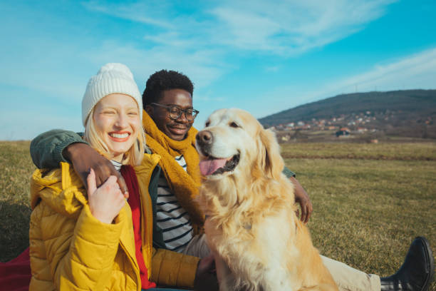 istock Couple playing with dogs 1363639823