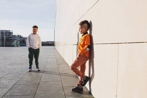 istock Two brothers playing together in a urban background. 1363642696