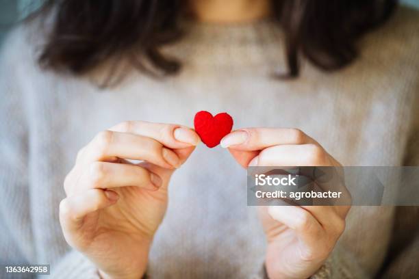 Woman Holding Tiny Heart Stock Photo - Download Image Now - Giving, Hand, Heart Shape