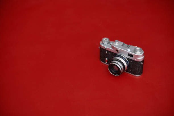 istock Vintage film camera on red background with copy space 1363643220