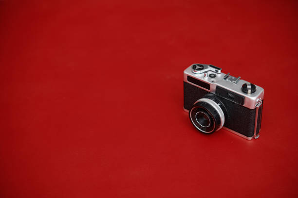 istock Vintage film camera on red background with copy space 1363643278