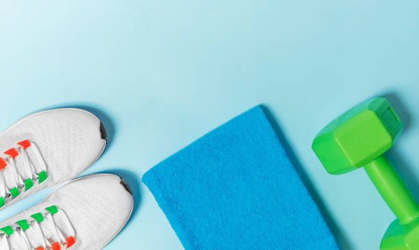 istock Sports set sneakers, dumbbell, towel on a light blue background 1363643292