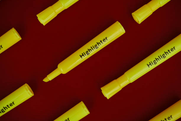Background pattern made out of yellow highlighter pens on a vibrant red background