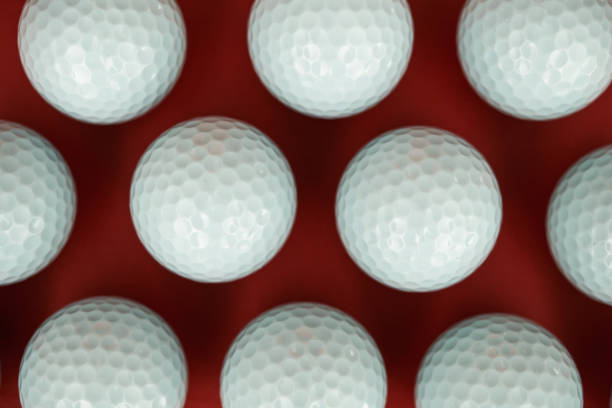 istock Background pattern made out of white golf balls on a vibrant red background 1363643463