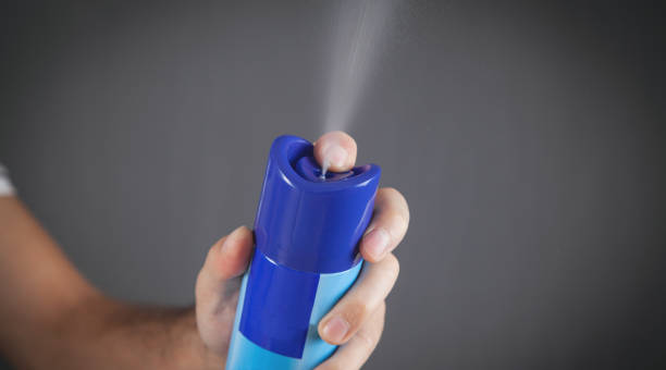 male hand spraying air freshener. - air freshener imagens e fotografias de stock