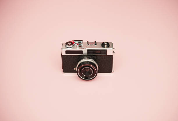 istock Vintage film camera on pastel pink background with copy space 1363644864
