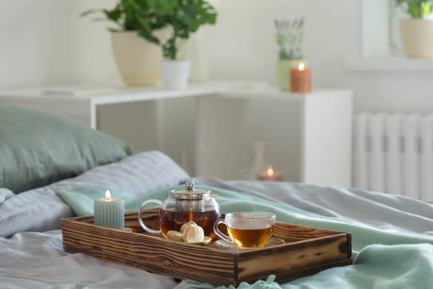 Crumpled bedding with tea and book for a relaxing day