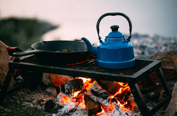 Teapot And Cast Iron Over Campfire Stock Photo - Download Image Now -  Camping, Campfire, Food - iStock