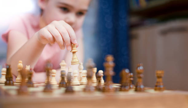 istock a girl plays chess and makes a king move 1363646137
