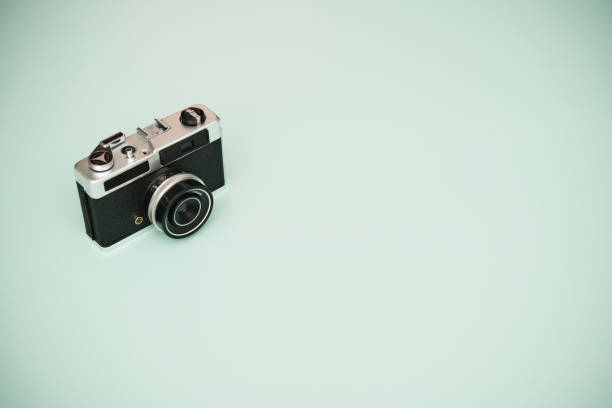 istock Vintage film camera on pastel green background with copy space 1363647518