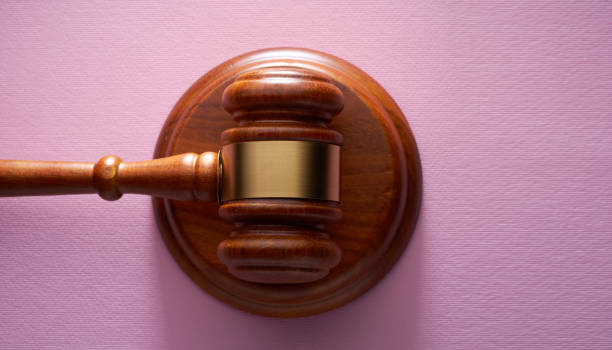 istock directly above gavel hammer  on pink background 1363648614