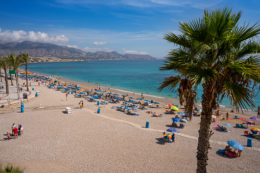 Albir Beach in Alfaz Alfas del Pi at Costa Blanca of Alicante Altea in Mediterranean sea of Spain. Playa del Albir located betwenn the famous landmarks of Altea and Benidorm is a sand and rolling stones beach in the Comunidad Valenciana with clean waters and  a target travel destination for international tourists.