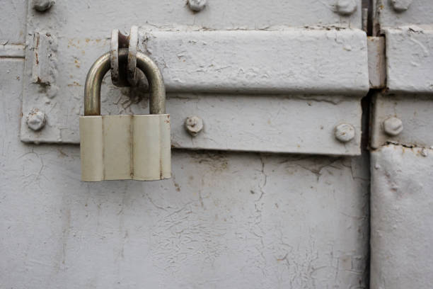istock Old padlock on metal gate close up view 1363649603
