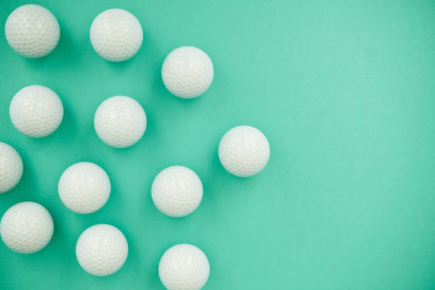 istock Background pattern made out of white golf balls on a vibrant teal background 1363652721