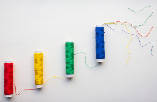 Multi coloured thread-sewing items next  to each other