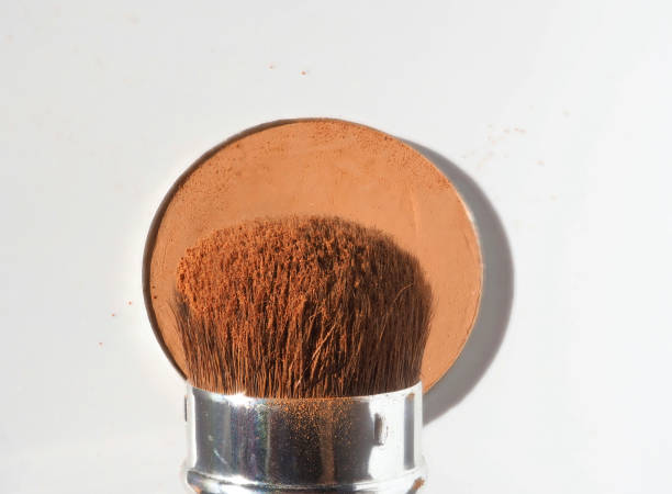 istock Nude makeup concept. Compact powder and brush 1363657681