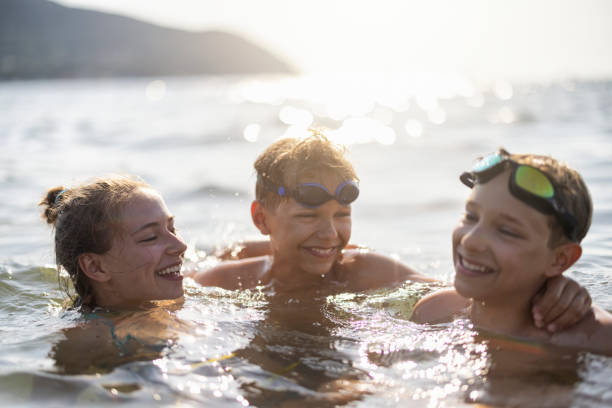 Kids enjoying summer vacations in the sea stock photo