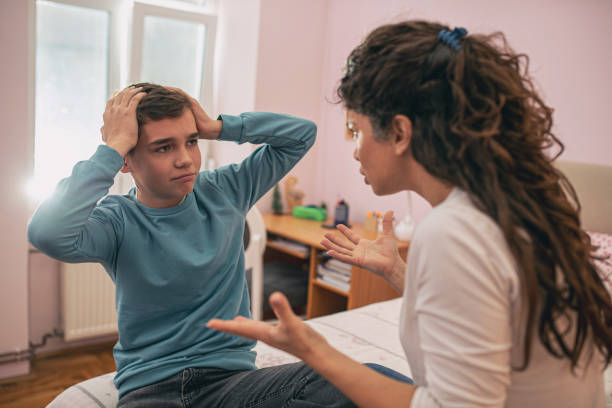 Mother and son having arguing and serious talk stock photo