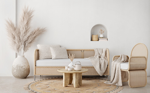 Sala de estar de estilo boho con silla de mimbre, sofá, mesa y pampas en la olla sobre fondo de pared blanco.3d representación photo