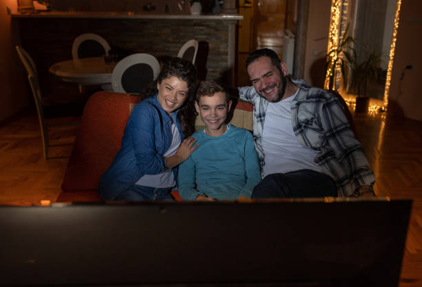 istock Happy family watching something funny on tv 1363661481