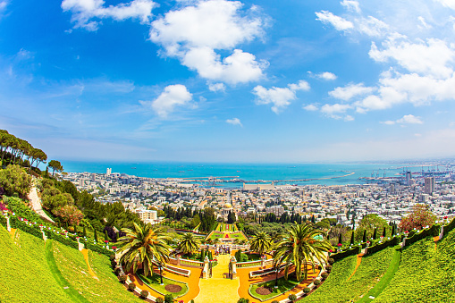 HAIFA, ISRAEL - MAY 6, 2017: Pilgrimage center and popular tourist destination. Bahai World Center. Sunny day by Mediterranean Sea. View from Mount Carmel to the seaport of Haifa.