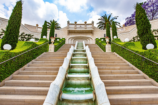 Picturesque cascade waterfall fountain. Marble staircase around the Mount Carmel Temple in Haifa, Israel. Bahai World Center. The descent to the Mediterranean Sea. Clear sunny day