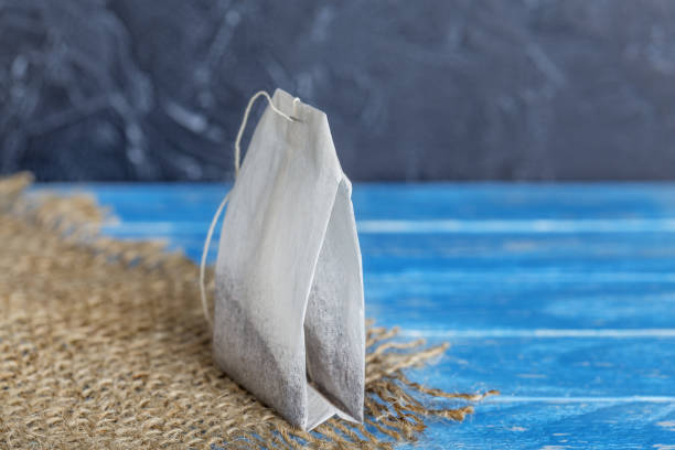 istock tea bag with herbs for tea on wooden table 1363665935