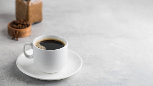 istock Black instant coffee in a white mug on a gray background. Copy space. 1363666699
