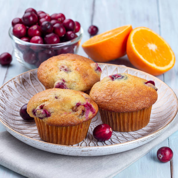 istock Cranberry orange muffins on wooden plate, square format 1363667957