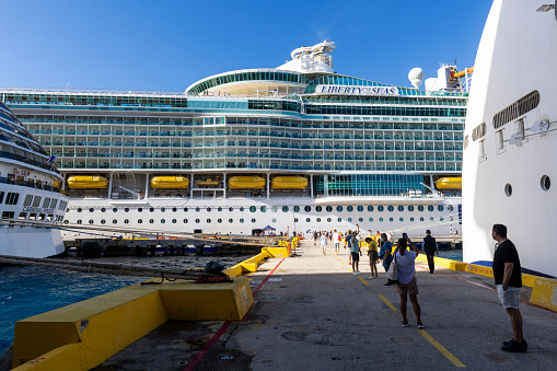 Mahahual, Mexico - January 6, 2022: Passengers disembark from one of several cruise ships, including the Liberty of the Seas and Carnival Pride, docked on Mexico's Costa Maya.