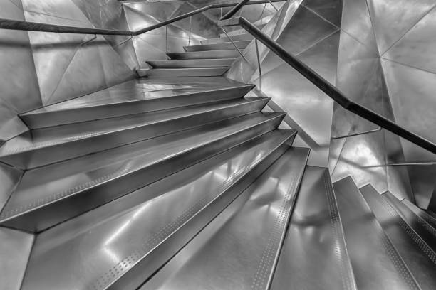 istock Silver metal spiral staircase modern staircase upwards with backlight. Abstract luxury minimalist architectural backdrop 1363668557