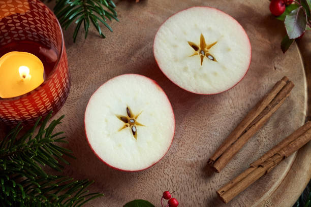 Winter apple decorated with cinnamon, star anis and ribbon