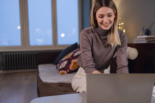 istock Young woman uses laptop at home at night 1363672310