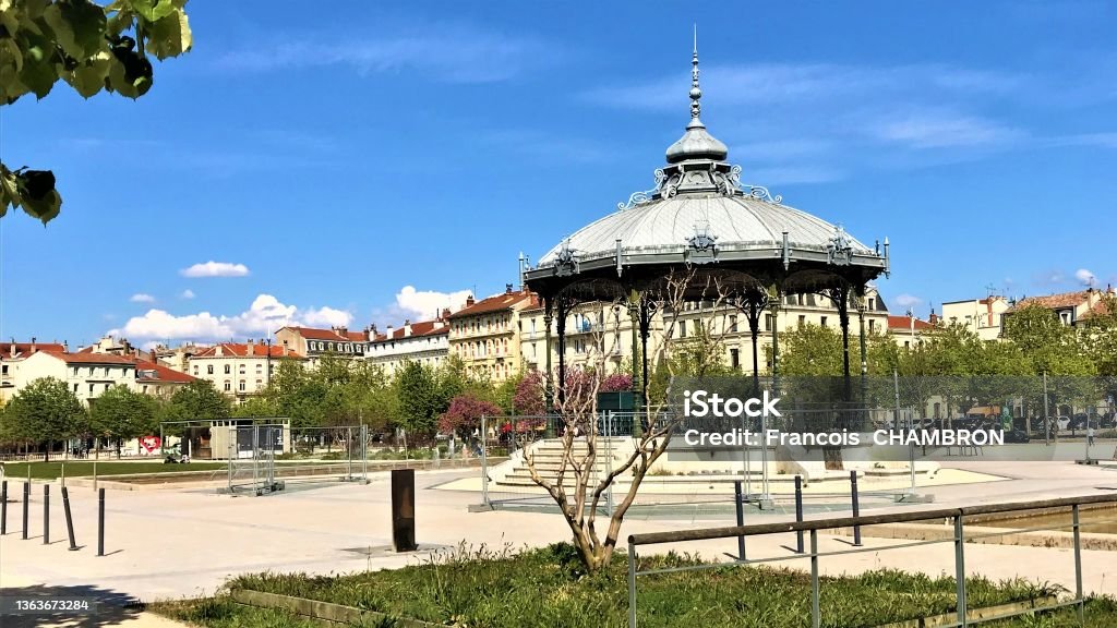 Valence France Champs de Mars with Peynet Kiosk Valence France Champs de Mars with Peynet Kiosque located in Drôme for lovers with flowered trees and blue sky Valence - Drôme Stock Photo
