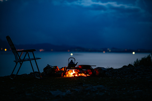Campfire and Camping Chair at Dusk