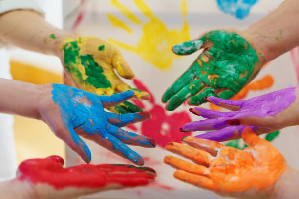 istock Female palms in colorful rainbow paint colors creating modern artwork to support LGBT community 1363677697