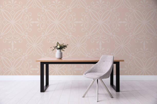 istock Table and chair near patterned wallpapers. Interior design 1363677860