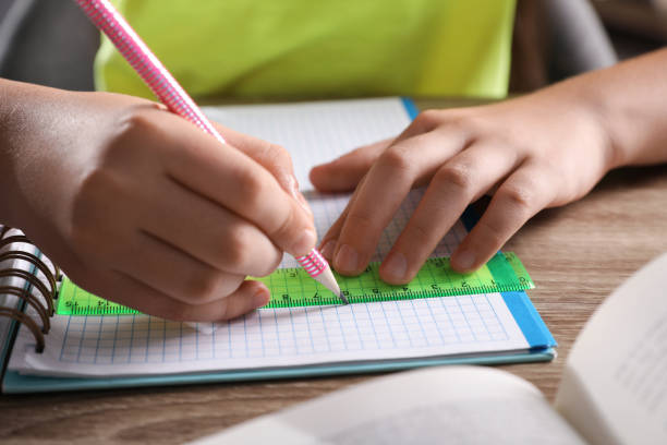istock Preteen girl doing homework at table, closeup 1363678850